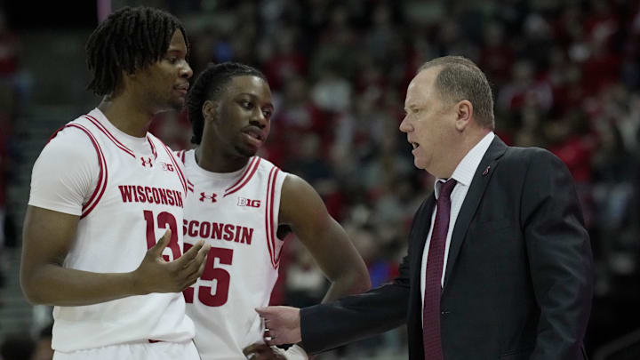 Wisconsin head coach Greg Gard talks two forward Xavier Amos (13) and guard John Blackwell (25) during the second half of their game Sunday, December 22, 2024 at the Kohl Center in Madison, Wisconsin. Wisconsin beat Detroit Mercy 76-53.