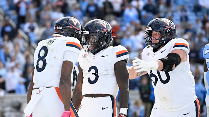 Oct 25, 2025; Chapel Hill, North Carolina, USA; Virginia Cavaliers running back J'Mari Taylor (3) celelbrates with wide receiver Jayden Thomas (8) and center Drake Metcalf (60) after scoring a touchdown in overtime at Kenan Stadium. Mandatory Credit: Bob Donnan-Imagn Images