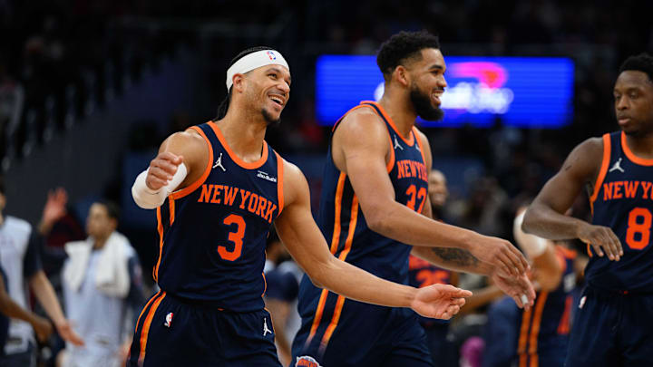 New York Knicks center Karl-Anthony Towns reacts with guard Josh Hart, and forward OG Anunoby after a field goal during the fourth quarter against the Washington Wizards at Capital One Arena on December 30, 2024. 