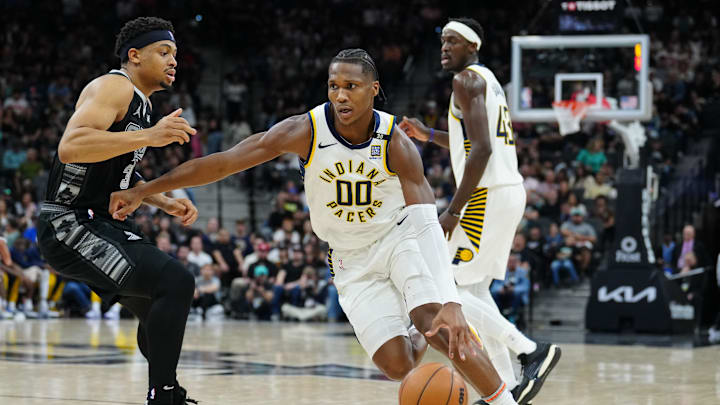 Mar 3, 2024; San Antonio, Texas, USA; Indiana Pacers guard Bennedict Mathurin (00) dribbles past San Antonio Spurs forward Keldon Johnson (3) in the first half at Frost Bank Center. Mandatory Credit: Daniel Dunn-Imagn Images