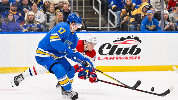 Jan 3, 2026; St. Louis, Missouri, USA; Montreal Canadiens left wing Juraj Slafkovsky (20) and St. Louis Blues defenseman Cam Fowler (17) battle for the puck during the third period at Enterprise Center. Mandatory Credit: Jeff Curry-Imagn Images