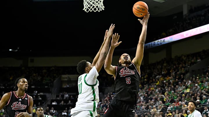 Mar 4, 2025; Eugene, Oregon, USA; Indiana Hoosiers forward Malik Reneau (5) shoots the ball against Oregon Ducks forward Kwame Evans Jr. (10) during the second half at Matthew Knight Arena. Mandatory Credit: Craig Strobeck-Imagn Images
