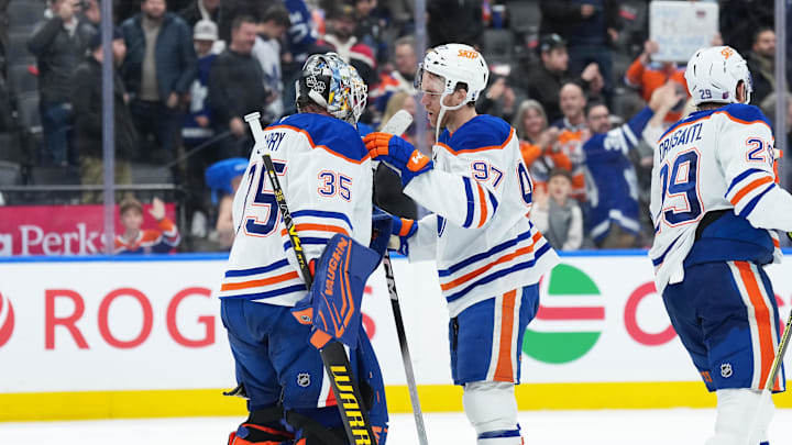 Dec 13, 2025; Toronto, Ontario, CAN; Edmonton Oilers center Connor McDavid (97) celebrates the win with goaltender Tristan Jarry (35) against the Toronto Maple Leafs at the end of the third period at Scotiabank Arena. Mandatory Credit: Nick Turchiaro-Imagn Images