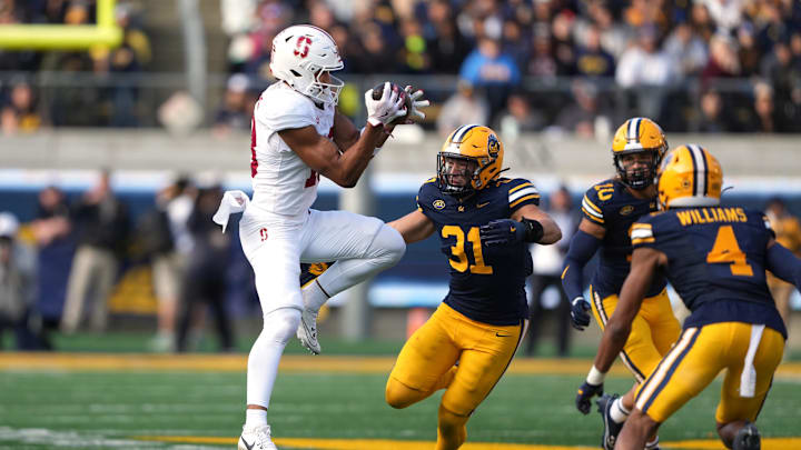 Nov 23, 2024; Berkeley, California, USA; Stanford Cardinal wide receiver Elic Ayomanor (left) catches a pass against California Golden Bears linebacker Hunter Barth (31) during the third quarter at California Memorial Stadium. Mandatory Credit: Darren Yamashita-Imagn Images