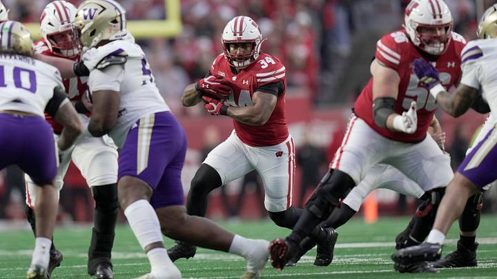 Wisconsin running back Jackson Acker (34) finds a seam in the Washington defense during the first quarter of their game Saturday, November 8, 2025 at Camp Randall Stadium in Madison, Wisconsin.