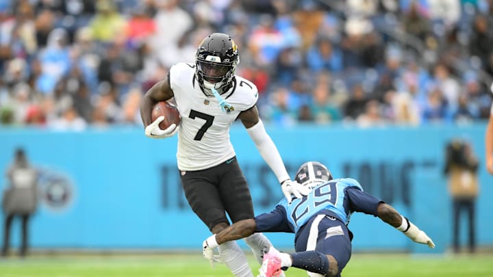Dec 8, 2024; Nashville, Tennessee, USA;   Jacksonville Jaguars wide receiver Brian Thomas Jr. (7) breaks the tackle of Tennessee Titans cornerback Jarvis Brownlee Jr. (29) during the second half at Nissan Stadium. Mandatory Credit: Steve Roberts-Imagn Images