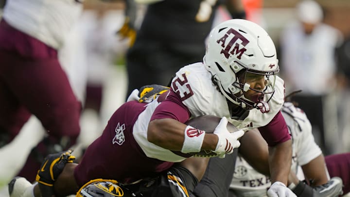 Nov 8, 2025; Columbia, Missouri, USA; Texas A&M Aggies running back Jamarion Morrow (23) dives forward against Missouri Tigers linebacker Triston Newson (14) during the first half at Faurot Field at Memorial Stadium. Mandatory Credit: Jay Biggerstaff-Imagn Images Nov 8, 2025; Columbia, Missouri, USA; Texas A&M Aggies running back Jamarion Morrow (23) dives forward against Missouri Tigers linebacker Triston Newson (14) during the first half at Faurot Field at Memorial Stadium. Mandatory Credit: Jay Biggerstaff-Imagn Images