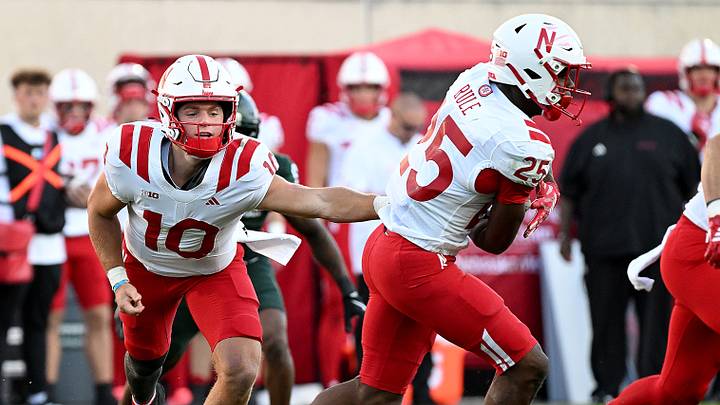 Sep 26, 2026; East Lansing, Michigan, USA; Nebraska Cornhuskers quarterback Anthony Colandrea (10) hands the ball to running back Jamal Rule (25) against the Michigan State Spartans at Spartan Stadium. Credit: Dale Young- Sep 26, 2026; East Lansing, Michigan, USA; Nebraska Cornhuskers quarterback Anthony Colandrea (10) hands the ball to running back Jamal Rule (25) against the Michigan State Spartans at Spartan Stadium. Credit: Dale Young-