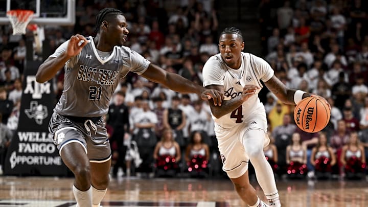 Nov 8, 2024; College Station, Texas, USA; Texas A&M Aggies guard Wade Taylor IV (4) dribbles the ball against East Texas A&M Lions forward KC Ugwuakazi (21) at Reed Arena. The Aggies defeated the Lions 87-55. Mandatory Credit: Maria Lysaker-Imagn Images 