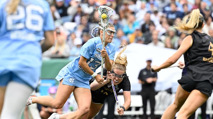 May 25, 2025; Foxborough, MA, USA; North Carolina Tar Heels midfielder Kate Levy (13) drives through Northwestern Wildcats midfielder Sam Smith (19) to the net during the second half at Gillette Stadium. Mandatory Credit: Eric Canha-Imagn Images