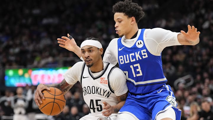 Dec 26, 2024; Milwaukee, Wisconsin, USA;  Milwaukee Bucks guard Ryan Rollins (13) defends Brooklyn Nets guard Keon Johnson (45) during the fourth quarter at Fiserv Forum. Mandatory Credit: Jeff Hanisch-Imagn Images