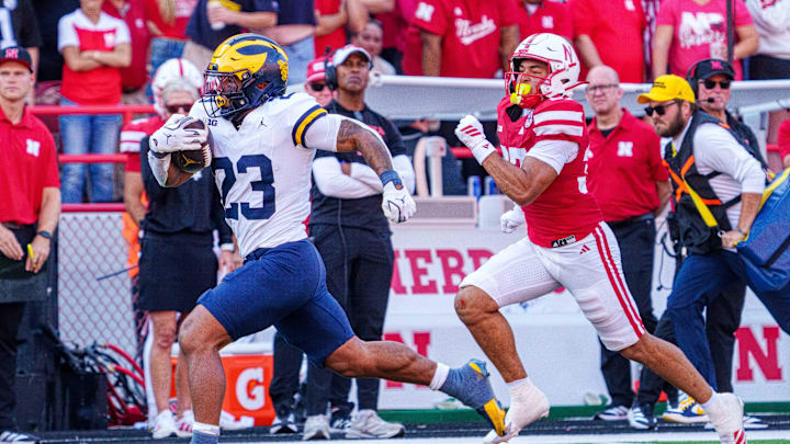 Sep 20, 2025; Lincoln, Nebraska, USA; Michigan Wolverines running back Jordan Marshall (23) runs for a touchdown against Nebraska Cornhuskers defensive back Donovan Jones (37) during the third quarter at Memorial Stadium. Mandatory Credit: Dylan Widger-Imagn Images