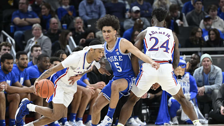 Nov 15, 2022; Indianapolis, Indiana, USA;  Kansas Jayhawks guard Dajuan Harris Jr. drives the ball around Duke basketball guard Tyrese Proctor