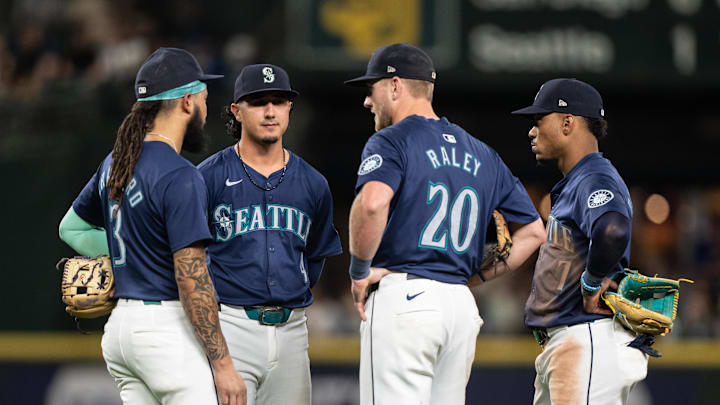 Seattle Mariners shortstop J.P. Crawford (3) third baseman Josh Rojas (4), first baseman Luke Raley (20) and second baseman Jorge Polanco (7), right, huddle during a pitching change during the sixth inning against the San Diego Padres at T-Mobile Park on Sept 10.
