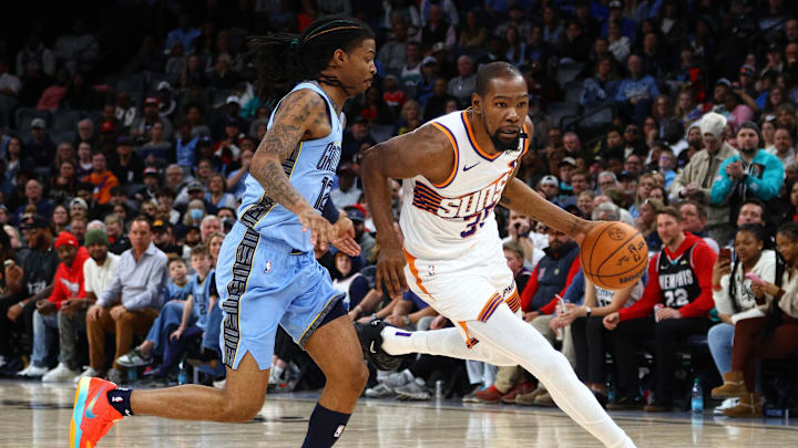 Feb 25, 2025; Memphis, Tennessee, USA; Phoenix Suns forward Kevin Durant (35) drives to the basket as Memphis Grizzlies guard Ja Morant (12) defends during the fourth quarter at FedExForum. Mandatory Credit: Petre Thomas-Imagn Images Feb 25, 2025; Memphis, Tennessee, USA; Phoenix Suns forward Kevin Durant (35) drives to the basket as Memphis Grizzlies guard Ja Morant (12) defends during the fourth quarter at FedExForum. Mandatory Credit: Petre Thomas-Imagn Images