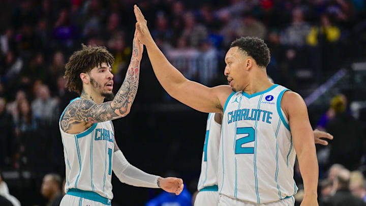 Jan 10, 2026; Salt Lake City, Utah, USA; Charlotte Hornets forward Grant Williams (2) and Charlotte Hornets guard LaMelo Ball (1) celebrate after making shot during the first half at Delta Center. Mandatory Credit: Peter Creveling-Imagn Images
