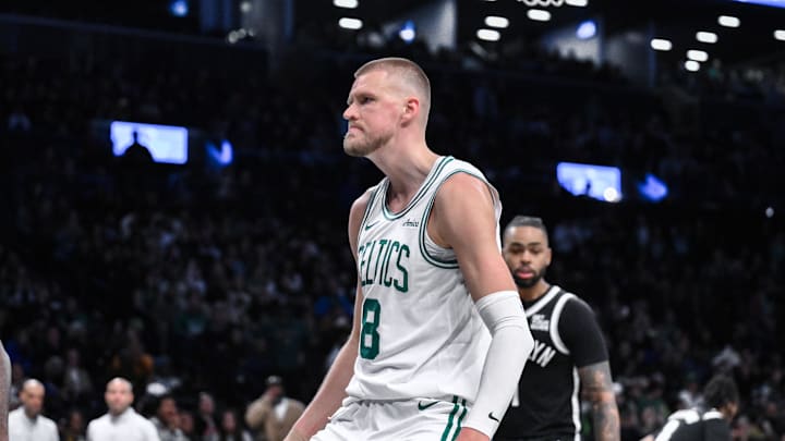 Mar 15, 2025; Brooklyn, New York, USA; Boston Celtics center Kristaps Porzingis (8) reacts after dunking the ball against the Brooklyn Nets during the second half at Barclays Center. Mandatory Credit: John Jones-Imagn Images