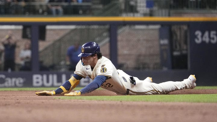 Aug 27, 2025; Milwaukee, Wisconsin, USA; Milwaukee Brewers outfielder Christian Yelich (22) slides safely into second base for a double against the Arizona Diamondbacks in the eighth inning at American Family Field. Mandatory Credit: Michael McLoone-Imagn Images