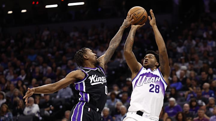 Oct 24, 2025; Sacramento, California, USA; Sacramento Kings guard Malik Monk (0) deflects the shot by Utah Jazz forward/guard Brice Sensabaugh (28) during the third quarter at Golden 1 Center. Mandatory Credit: Kelley L Cox-Imagn Images
