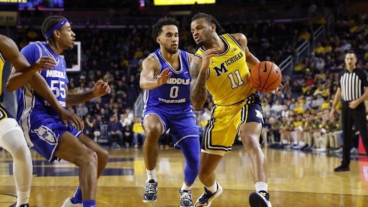 Nov 19, 2025; Ann Arbor, Michigan, USA; Michigan Wolverines guard Roddy Gayle Jr. (11) dribbles defended by Middle Tennessee Blue Raiders guard Alec Oglesby (0) in the first half at Crisler Center. Mandatory Credit: Rick Osentoski-Imagn Images