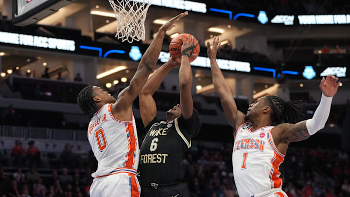 Mar 11, 2026; Charlotte, NC, USA; Wake Forest Demon Deacons guard Myles Colvin (6) shoots as Clemson Tigers forward RJ Godfrey (0) and guard Jestin Porter (1) defend in the first half at Spectrum Center. Mandatory Credit: Bob Donnan-Imagn Images