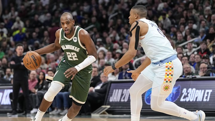 Jan 8, 2025; Milwaukee, Wisconsin, USA;  Milwaukee Bucks forward Khris Middleton (22) drives for the basket against San Antonio Spurs forward Keldon Johnson (0) during the third quarter at Fiserv Forum. Mandatory Credit: Jeff Hanisch-Imagn Images