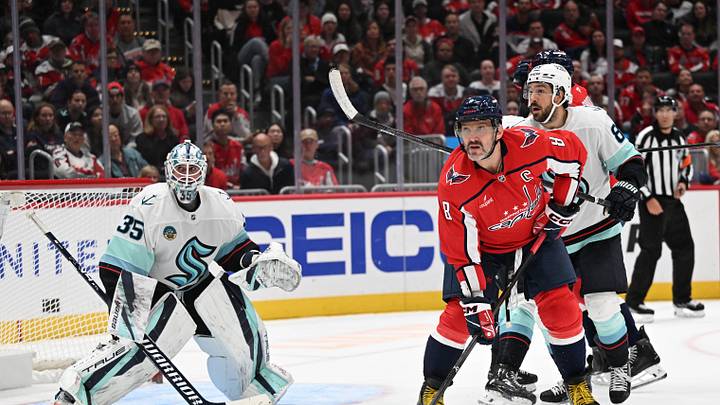 Oct 11, 2026; Washington, District of Columbia, USA; Washington Capitals left wing Alex Ovechkin (8) looks for the puck in front of Seattle Kraken goaltender Joey Daccord (35) during the third period at Capital One Arena. Mandatory Credit: Brad Mills-Imagn Images