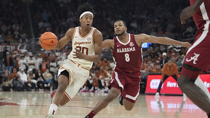 Feb 11, 2025; Austin, Texas, USA; Texas Longhorns guard Tre Johnson (20) drives to the basket against Alabama Crimson Tide guard Chris Youngblood (8) during the first half at Moody Center. Mandatory Credit: Scott Wachter-Imagn Images