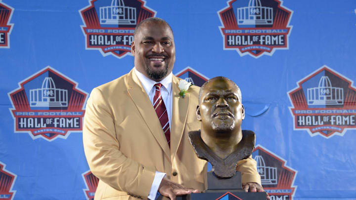 Aug 2, 2014; Canton, OH, USA; Walter Jones poses with bust at the 2014 Pro Football Hall of Fame Enshrinement at Fawcett Stadium. Mandatory Credit: Kirby Lee-Imagn Images