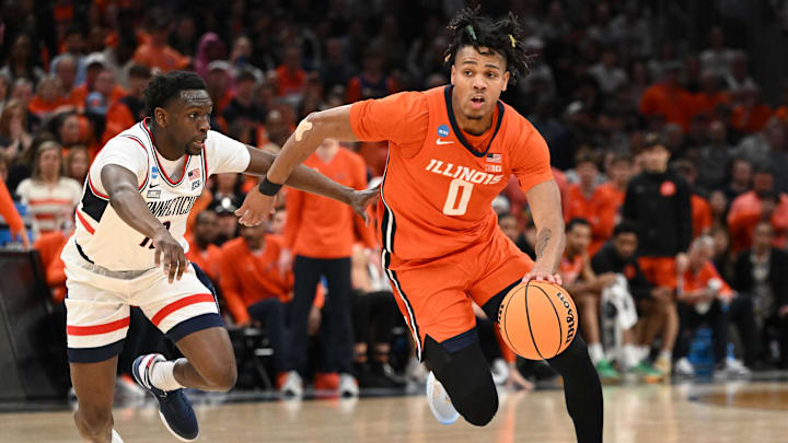 Mar 30, 2024; Boston, MA, USA; Illinois Fighting Illini guard Terrence Shannon Jr. (0) dribbles the ball against Connecticut Huskies guard Hassan Diarra (10) in the finals of the East Regional of the 2024 NCAA Tournament at TD Garden. Mandatory Credit: Brian Fluharty-USA TODAY Sports