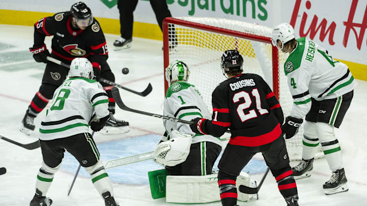 Jan 12, 2025; Ottawa, Ontario, CAN; Ottawa Senators center Matthew Highmore (15) swings at the puck in front of Dallas Stars goalie Casey DeSmith (1) in the third period at the Canadian Tire Centre. Mandatory Credit: Marc DesRosiers-Imagn Images