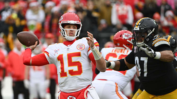 Dec 25, 2024; Pittsburgh, Pennsylvania, USA; Kansas City Chiefs quarterback Patrick Mahomes (15) throws a pass while being pressured by Pittsburgh Steelers defensive tackle Cameron Heyward (97) during the first quarter at Acrisure Stadium. Mandatory Credit: Barry Reeger-Imagn Images