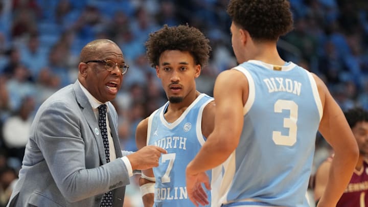 Dec 30, 2025; Chapel Hill, North Carolina, USA; North Carolina Tar Heels head coach Hubert Davis with guard Seth Trimble (7) and guard Derek Dixon (3) in the second half at Dean E. Smith Center. Mandatory Credit: Bob Donnan-Imagn Images