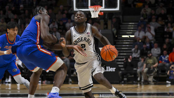 Jan 17, 2026; Nashville, Tennessee, USA;  Vanderbilt Commodores guard Duke Miles (2) drives to the basket past Florida Gators center Rueben Chinyelu (9) during the second half at Memorial Gymnasium. Mandatory Credit: Steve Roberts-Imagn Images