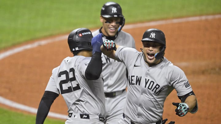 Oct 18, 2024; Cleveland, Ohio, USA; New York Yankees designated hitter Giancarlo Stanton (27) celebrates a three run home run with outfielder Juan Soto (22) in the sixth inning against the Cleveland Guardians during game four of the ALCS for the 2024 MLB playoffs at Progressive Field. Mandatory Credit: David Richard-Imagn Images