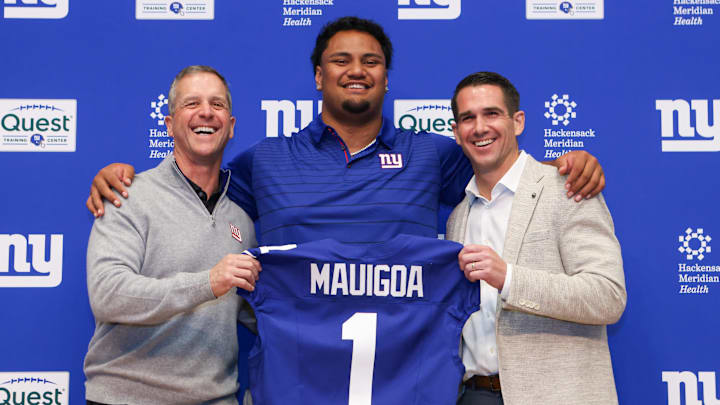Apr 24, 2026; East Rutherford, NJ, USA; New York Giants draft pick Francis Mauigoa, Head Coach John Harbaugh (left) and General Manager Joe Schoen  (right) pose for a photo during the introductory press conference at Quest Diagnostics Training Center.  