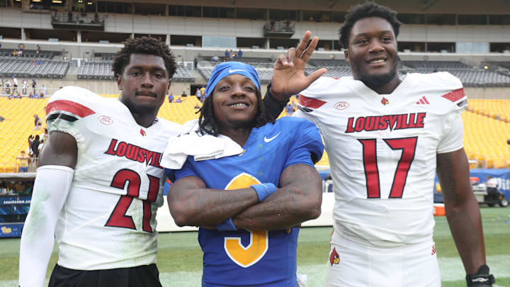 Sep 27, 2025; Pittsburgh, Pennsylvania, USA;  Pittsburgh Panthers wide receiver Cataurus Hicks (3) poses for a photo with Louisville Cardinals defensive back D'Angelo Hutchinson (21) and defensive lineman AJ Green (17) after the game at Acrisure Stadium. Mandatory Credit: Charles LeClaire-Imagn Images