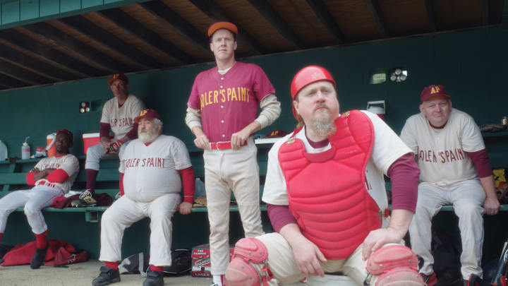 The Adler's Paint team looks on from the dugout.