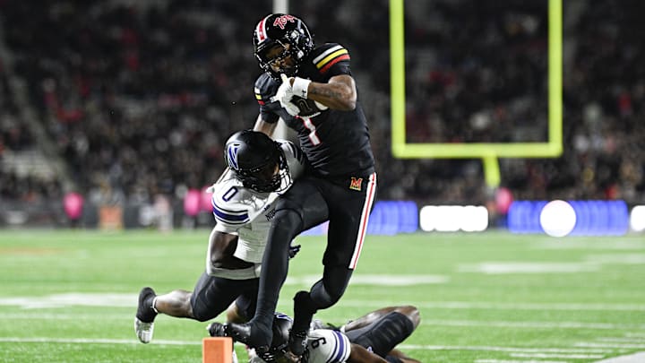 Oct 11, 2024; College Park, Maryland, USA;  Northwestern Wildcats defensive back Coco Azema (0) hits Maryland Terrapins wide receiver Kaden Prather (1) out of bounds before the goal line during the second half at SECU Stadium.