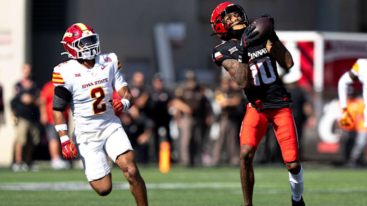 Cincinnati Bearcats wide receiver Caleb Goodie (10) catches a pass and runs for a touchdown as Iowa State Cyclones defensive back Jamison Patton (2) defends in the fourth quarter of the NCAA football game between the Cincinnati Bearcats and Iowa State Cyclones at Nippert Stadium in Cincinnati on Oct. 4, 2025. Cincinnati Bearcats wide receiver Caleb Goodie (10) catches a pass and runs for a touchdown as Iowa State Cyclones defensive back Jamison Patton (2) defends in the fourth quarter of the NCAA football game between the Cincinnati Bearcats and Iowa State Cyclones at Nippert Stadium in Cincinnati on Oct. 4, 2025.