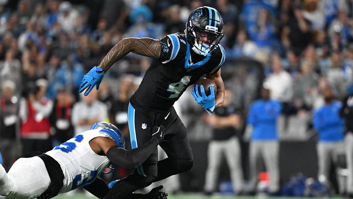 Oct 4, 2026; Charlotte, North Carolina, USA;  Carolina Panthers wide receiver Tetairoa McMillan (4) carries the ball after a reception defended by Detroit Lions safety Chuck Clark (36) during the fourth quarter at Bank of America Stadium.  Mandatory Credit: Bob Donnan-Imagn Images