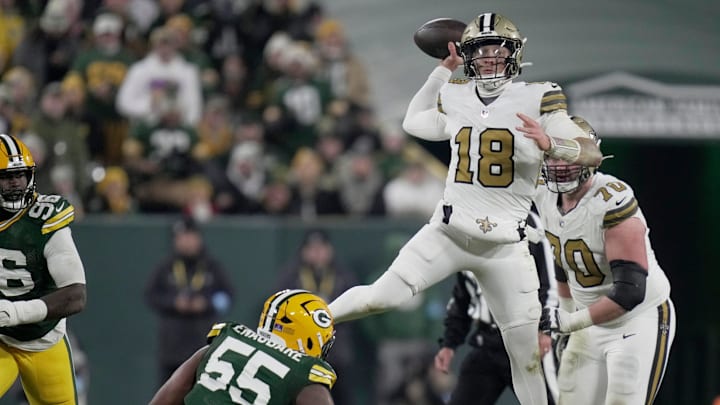 New Orleans Saints quarterback Spencer Rattler (18) is pressured by Green Bay Packers defensive end Kingsley Enagbare (55) during the third quarter of their game Monday, December 23, 2024 at Lambeau Field in Green Bay, Wisconsin.