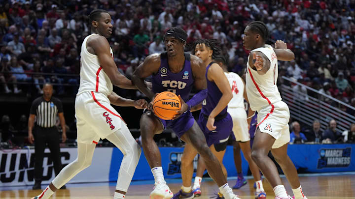 Mar 20, 2022; San Diego, CA, USA; TCU Horned Frogs forward Emanuel Miller (2) controls the ball against Arizona Wildcats center Christian Koloko (35) and guard Bennedict Mathurin (0) in the second half during the second round of the 2022 NCAA Tournament at Viejas Arena. Mandatory Credit: Kirby Lee-Imagn Images
