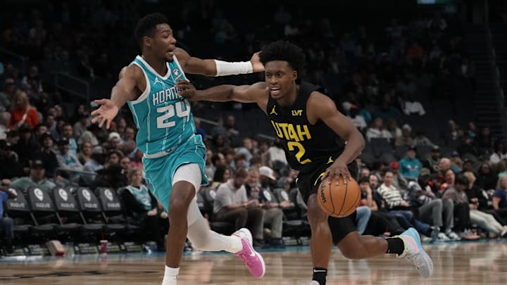 Jan 27, 2024; Charlotte, North Carolina, USA; Utah Jazz guard Collin Sexton (2) handles the ball against a pleading Charlotte Hornets forward Brandon Miller (24) during the second half at Spectrum Center. Mandatory Credit: Jim Dedmon-Imagn Images