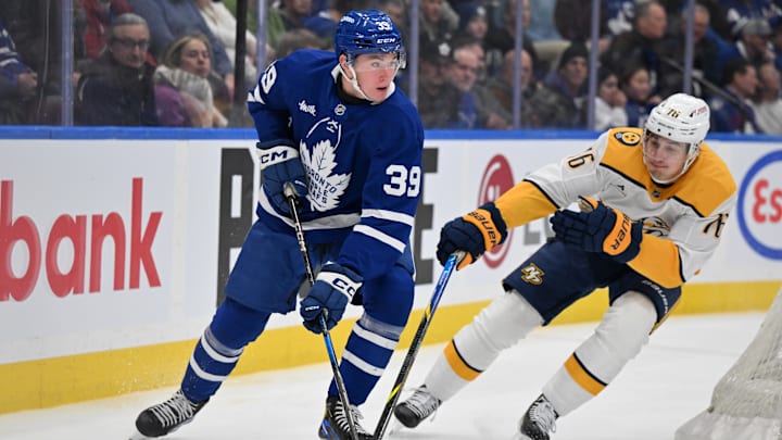 Dec 4, 2024; Toronto, Ontario, CAN;  Toronto Maple Leafs forward Fraser Minten (39) controls the puck against Nashville Predators defenseman Brady Skjei (76) in the first period at Scotiabank Arena. Mandatory Credit: Dan Hamilton-Imagn Images