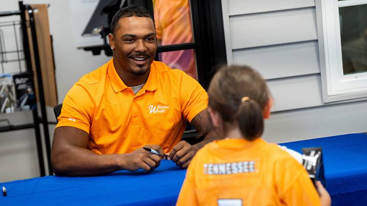 Tennessee linebacker Arion Carter smiles as he tells a young Vols fan that he likes her jersey during a meet and greet at Window World of Knoxville on Aug. 20, 2026. Tennessee linebacker Arion Carter smiles as he tells a young Vols fan that he likes her jersey during a meet and greet at Window World of Knoxville on Aug. 20, 2026.