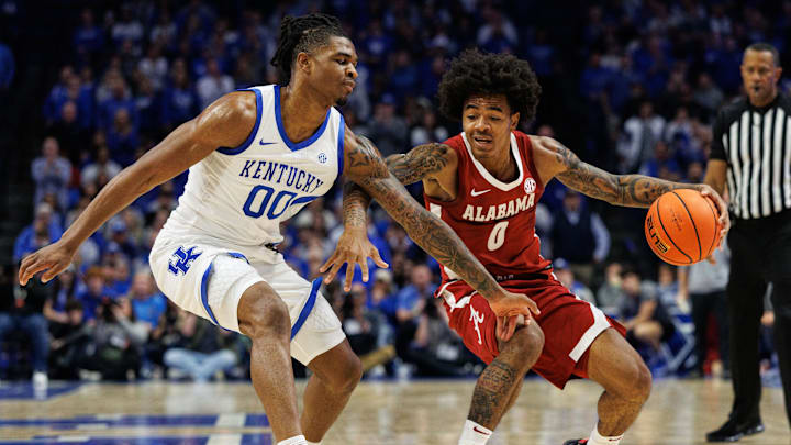 Jan 18, 2025; Lexington, Kentucky, USA; Alabama Crimson Tide guard Labaron Philon (0) dribbles the ball around Kentucky Wildcats guard Otega Oweh (00) during the first half at Rupp Arena at Central Bank Center. Mandatory Credit: Jordan Prather-Imagn Images