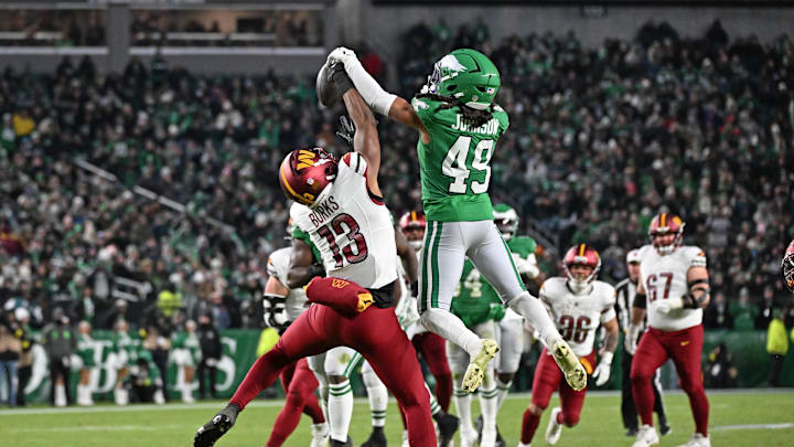 Jan 4, 2026; Philadelphia, Pennsylvania, USA; Philadelphia Eagles safety Brandon Johnson (49) breaks up pass intended for Washington Commanders wide receiver Treylon Burks (13) at Lincoln Financial Field. 