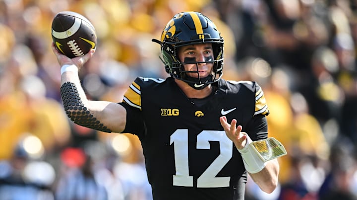 Oct 12, 2024; Iowa City, Iowa, USA; Iowa Hawkeyes quarterback Cade McNamara (12) throws a pass against the Washington Huskies during the first quarter at Kinnick Stadium. Oct 12, 2024; Iowa City, Iowa, USA; Iowa Hawkeyes quarterback Cade McNamara (12) throws a pass against the Washington Huskies during the first quarter at Kinnick Stadium.
