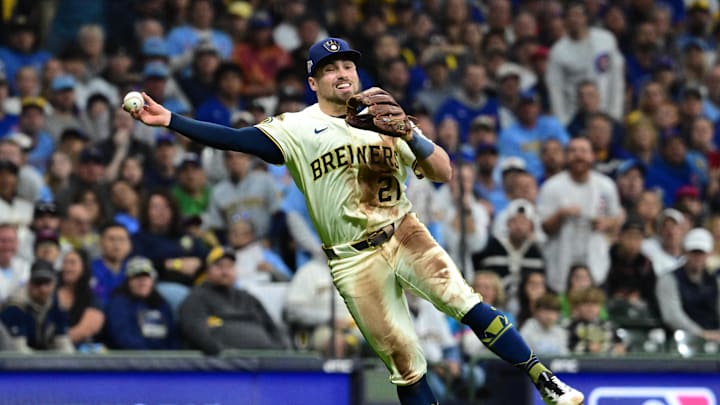 Oct 11, 2025; Milwaukee, Wisconsin, USA; Milwaukee Brewers third baseman Caleb Durbin (21) throws out Chicago Cubs third baseman Matt Shaw (6) in the third inning during game five of the NLDS round for the 2025 MLB playoffs at American Family Field. Mandatory Credit: Benny Sieu-Imagn Images